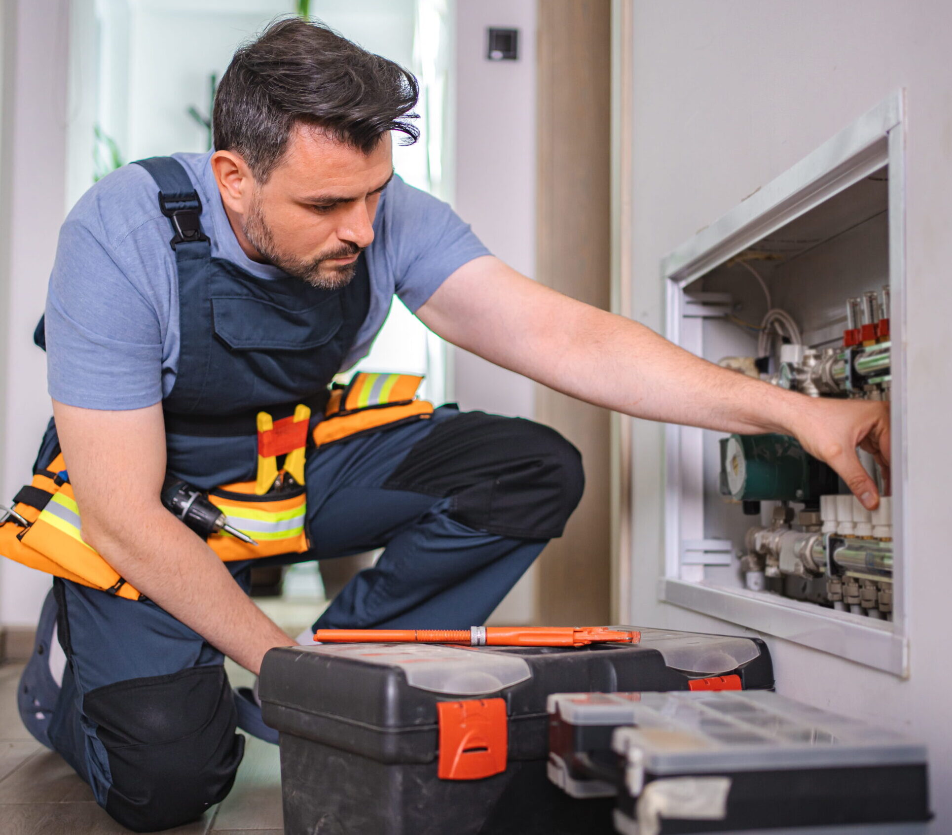 worker checking hvac system scaled e1776251327423.jpg
